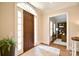 Light-filled foyer showcases an elegant doorway and glimpses of a wood-paneled study at 5827 Rileys Ridge Rd, Charlotte, NC 28226