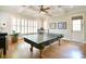 Game room featuring coffered ceilings, hardwood floors, shuttered windows, and a ping pong table at 5827 Rileys Ridge Rd, Charlotte, NC 28226