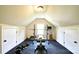 Well-lit gym with rubber flooring and weightlifting equipment, including squat rack and dumbbells at 5827 Rileys Ridge Rd, Charlotte, NC 28226