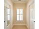 Hallway with natural light from a window and mirrors on the doors creating a sense of openness at 5827 Rileys Ridge Rd, Charlotte, NC 28226