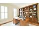Bright home office features a large built-in bookcase and a spacious wooden desk at 5827 Rileys Ridge Rd, Charlotte, NC 28226
