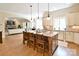 A spacious kitchen has a large island with seating that looks into the living room at 5827 Rileys Ridge Rd, Charlotte, NC 28226