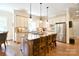 A bright kitchen features an island with granite countertops and stainless steel appliances at 5827 Rileys Ridge Rd, Charlotte, NC 28226