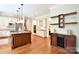 A bright kitchen with a cooktop island connects to the dining area and living spaces at 5827 Rileys Ridge Rd, Charlotte, NC 28226