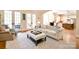 Cozy living room featuring a plush sofa, ottoman, French doors, and views to the kitchen and breakfast nook at 5827 Rileys Ridge Rd, Charlotte, NC 28226