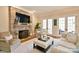 The cozy living room is enhanced by a stone fireplace and French doors at 5827 Rileys Ridge Rd, Charlotte, NC 28226