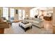 The living room opens to a patio through French doors and connects to the kitchen at 5827 Rileys Ridge Rd, Charlotte, NC 28226