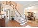 Grand foyer with hardwood floors features a turned staircase and a view into the formal dining room at 5827 Rileys Ridge Rd, Charlotte, NC 28226