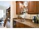 Convenient wet bar with granite countertops, custom cabinetry, and glass shelving for storage at 5827 Rileys Ridge Rd, Charlotte, NC 28226