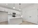 Modern kitchen featuring white cabinets, stainless steel appliances, and a central island with stylish pendant lights at 622 Old Salisbury Rd, Statesville, NC 28677