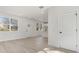 Bright living room with large windows, light wood floors, and an open layout flowing into the modern kitchen at 622 Old Salisbury Rd, Statesville, NC 28677