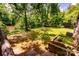 A view from the deck of a grassy backyard with mature trees at 6510 Sharon Hills Rd, Charlotte, NC 28210
