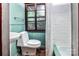 Bright bathroom with a white toilet, green-painted walls, and a sink with a vanity at 6510 Sharon Hills Rd, Charlotte, NC 28210