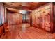 Warm bedroom featuring wood floors, wood-paneled walls, recessed lighting, and closet space at 6510 Sharon Hills Rd, Charlotte, NC 28210