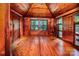 Charming bedroom with wood paneling, hardwood floors, a high ceiling, and ample natural light at 6510 Sharon Hills Rd, Charlotte, NC 28210
