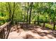 Deck featuring a table and chairs surrounded by lush green trees at 6510 Sharon Hills Rd, Charlotte, NC 28210