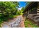 Exterior view featuring a stone pathway leading to the log cabin at 6510 Sharon Hills Rd, Charlotte, NC 28210