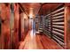 Cozy hallway with wood paneling, hardwood floors, and a spiral staircase leading to another level at 6510 Sharon Hills Rd, Charlotte, NC 28210