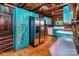 Rustic log cabin kitchen featuring stainless steel appliances, wooden floors, and custom blue cabinetry at 6510 Sharon Hills Rd, Charlotte, NC 28210