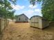 Spacious backyard featuring a storage shed and partial fence, ideal for outdoor activities at 652 Wilson St, Kannapolis, NC 28083