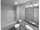 Bright bathroom showcasing a granite vanity and a well-maintained shower-tub at 652 Wilson St, Kannapolis, NC 28083