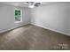 This bedroom includes neutral carpet and a ceiling fan at 652 Wilson St, Kannapolis, NC 28083