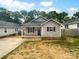Charming single story home featuring black shutters, covered front porch, and freshly mulched flower beds at 652 Wilson St, Kannapolis, NC 28083