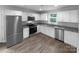 Bright, modern kitchen featuring white cabinets, stainless steel appliances, and granite countertops at 652 Wilson St, Kannapolis, NC 28083