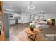 Open-concept living area with bright white paint, modern furniture, and wood-look floors at 652 Wilson St, Kannapolis, NC 28083