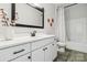 Bright bathroom with a white vanity, sleek black hardware, quartz counters, and decorative floral accents at 754 Culp Ferguson Rd, Lancaster, SC 29720