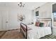 Bright bedroom with a black iron bed frame, neutral decor, and soft natural light from a nearby window at 754 Culp Ferguson Rd, Lancaster, SC 29720