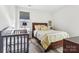 Comfortable bedroom with a wooden bed frame, a gray crib, and natural light from a nearby window at 754 Culp Ferguson Rd, Lancaster, SC 29720