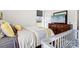 Bright bedroom with a crib, TV atop a chest, soft bedding, and natural light from a nearby window at 754 Culp Ferguson Rd, Lancaster, SC 29720