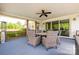 Covered patio with wicker furniture, ceiling fan, and a view of the green backyard landscape at 754 Culp Ferguson Rd, Lancaster, SC 29720