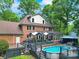 Spacious backyard featuring a refreshing pool, deck, and mature trees, creating a private outdoor oasis at 8524 Quarters Ln, Mint Hill, NC 28227