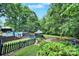 Beautifully landscaped backyard featuring a swimming pool, gazebo, and play area at 8524 Quarters Ln, Mint Hill, NC 28227