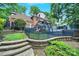 Expansive backyard with lush greenery, multi-level deck, and swimming pool at 8524 Quarters Ln, Mint Hill, NC 28227