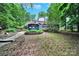 Expansive backyard with a gazebo, patio, and lush landscaping, ideal for outdoor entertaining and relaxation at 8524 Quarters Ln, Mint Hill, NC 28227