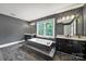 Well-lit bathroom with a soaking tub, black cabinets, dual sinks and ample counter space at 8524 Quarters Ln, Mint Hill, NC 28227