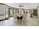 Bright dining area with table and chairs, large windows, tile flooring, and an open floor plan to the kitchen at 8524 Quarters Ln, Mint Hill, NC 28227