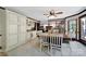 Open dining area with a spacious table, built-in cabinetry, tile floors, and view to the fireplace and living room at 8524 Quarters Ln, Mint Hill, NC 28227