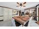 Bright dining area features a large dining table, custom cabinets, and an open view to the cozy living room at 8524 Quarters Ln, Mint Hill, NC 28227