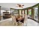 Dining area with wood table and chairs, adjacent to living room and access to outdoor patio at 8524 Quarters Ln, Mint Hill, NC 28227