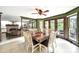 Cozy dining room with tile floors, view to brick fireplace, and backyard views at 8524 Quarters Ln, Mint Hill, NC 28227