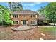 Charming brick home featuring a symmetrical facade, manicured landscaping, and a welcoming entrance at 8524 Quarters Ln, Mint Hill, NC 28227