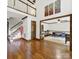 Bright foyer featuring hardwood floors, a staircase, and views of a game room at 8524 Quarters Ln, Mint Hill, NC 28227