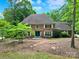 Charming brick home with a well-manicured lawn and mature trees, offering a serene and inviting curb appeal at 8524 Quarters Ln, Mint Hill, NC 28227
