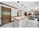 Open concept kitchen with island, granite counters, pendant lighting and access to dining area at 8524 Quarters Ln, Mint Hill, NC 28227