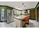 Bright kitchen features stainless steel appliances and a large island with breakfast bar at 8524 Quarters Ln, Mint Hill, NC 28227