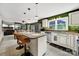 Open kitchen featuring an island, granite countertops, stainless steel appliances, and bright lighting at 8524 Quarters Ln, Mint Hill, NC 28227